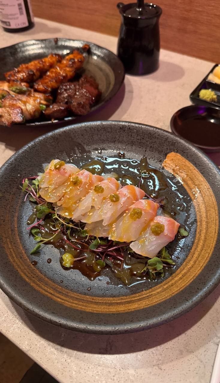 Yellowtail carpaccio crudo with yuzu ponzu and microgreens